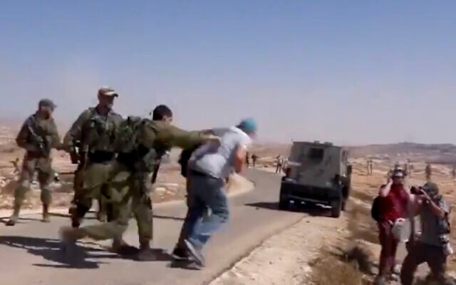 Video shows an Israeli soldier shoving an activist from the left-wing Combatants for Peace group during a protest in the southern West Bank, on September 17, 2021. (Screenshot/Twitter) Video shows an Israeli soldier shoving an activist from the left-wing Combatants for Peace group during a protest in the southern West Bank, on September 17, 2021. (Screenshot/Twitter)