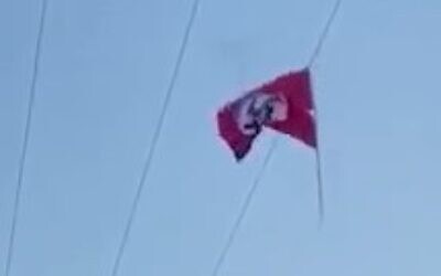 A Nazi flag attacked to electrical cables in the Palestinian village of Beit Ummar in the West Bank, on September 26, 2021. (Screenshot/Instagram)
