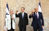 President Isaac Herzog (center), his wife, Michal, and Foreign Minister Yair Lapid, hold a toast ahead of the Jewish New Year for diplomatic corps, on September 2, 2021 in Jerusalem. (Amos Ben Gershom/GPO)