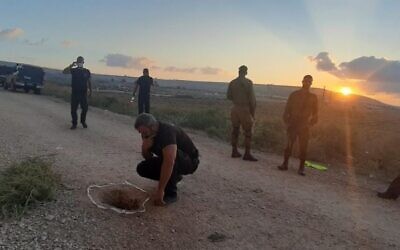 Investigators inspect the hole used by six inmates to escape Gilboa Prison, on September 6, 2021. (Israel Prison Service)