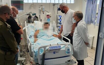 Defense Minister Benny Gantz visits one of the soldiers hurt in the West Bank raid against a Hamas cell, at Haifa’s Rambam Medical Center, September 27, 2021. (courtesy)