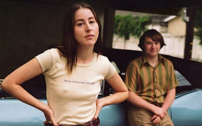 Alana Haim and Cooper Hoffman in a promotional poster image for "Licorice Pizza." (MGM via JTA)