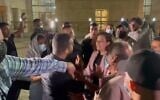 Channel 13 reporter Ali Mograbi faces off with a group of angry protesters outside the Nazareth District Court on September 11, 2021. (Screenshot)