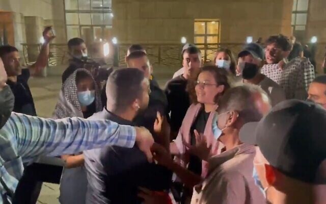 Channel 13 reporter Ali Mograbi faces off with a group of angry protesters outside the Nazareth District Court on September 11, 2021. (Screenshot) Channel 13 reporter Ali Mograbi faces off with a group of angry protesters outside the Nazareth District Court on September 11, 2021. (Screenshot)