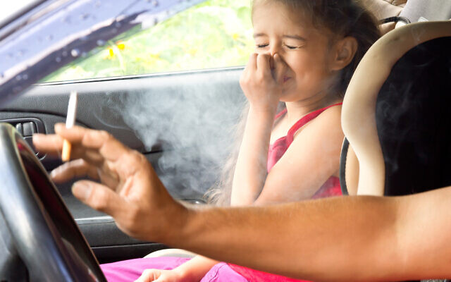 A child breathing her father's smoke (iStock)