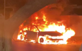 A burning car is seen by the entrance of Sajur on Sepetember 8, 2021. (Video screenshot)