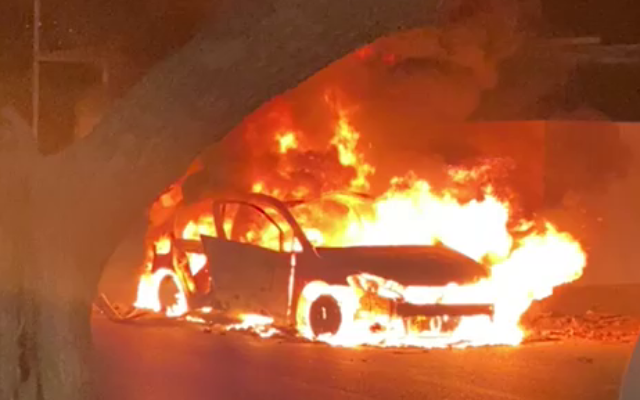 A burning car is seen by the entrance of Sajur on Sepetember 8, 2021. (Video screenshot) A burning car is seen by the entrance of Sajur on Sepetember 8, 2021. (Video screenshot)
