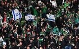 Israel's Maccabi Haifa fans display Israeli flags in the stands, during the UEFA Conference League Group E first leg football match between FC Union Berlin and Maccabi Haifa in the Olympic Stadium in Berlin, on September 30, 2021. (Matthias Koch/DPA/AFP/Germany Out)