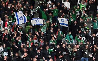 Israel's Maccabi Haifa fans display Israeli flags in the stands, during the UEFA Conference League Group E first leg football match between FC Union Berlin and Maccabi Haifa in the Olympic Stadium in Berlin, on September 30, 2021. (Matthias Koch/DPA/AFP/Germany Out)