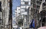 A mesh of raised electricity lines along a street in a suburb of Lebanon's capital Beirut, June 23, 2021. (Joseph EID / AFP)