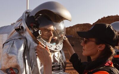 Technicians assist an astronaut from a team from Europe and Israel to suit up in a spacesuit before starting a training mission for planet Mars at a site that simulates an off-site station at the Ramon Crater in Mitzpe Ramon in Israel's southern Negev desert on October 10, 2021. (Photo by JACK GUEZ / AFP)