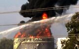 Firefighters try to extinguish a fire in one of the tanks at the Zahrani oil facility in southern Lebanon on October 11, 2021, sparking alarm as the country grapples with dire hydrocarbon shortages. (Mahmoud ZAYYAT / AFP)