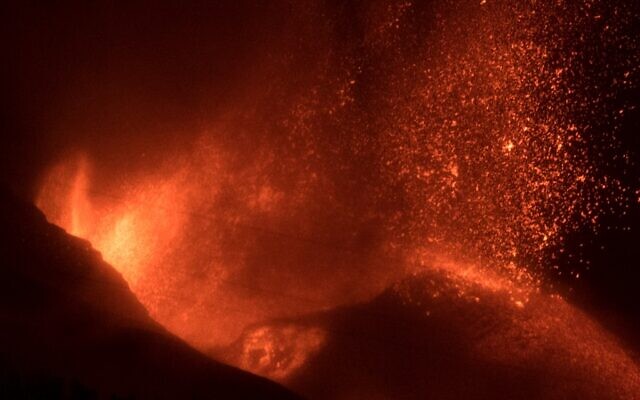 The Cumbre Vieja volcano, pictured at night from El Paso, spews lava, ash and smoke, in the Canary Island of La Palma, on October 11, 2021. (Jorge Guerrero/AFP)