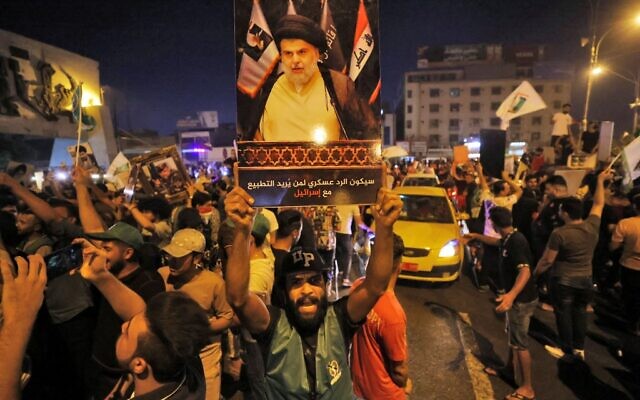 Supporters of Iraqi Shiite cleric Moqtada al-Sadr celebrate in Baghdad's Tahrir square following the announcement of parliamentary elections' results on October 11, 2021. (AHMAD AL-RUBAYE / AFP) Supporters of Iraqi Shiite cleric Moqtada al-Sadr celebrate in Baghdad's Tahrir square following the announcement of parliamentary elections' results on October 11, 2021. (AHMAD AL-RUBAYE / AFP)