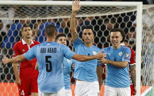 Israel's forward Eran Zahavi (C) celebrates his record-breaking 33rd national goal with teammates during the 2022 Qatar World Cup Asian Qualifiers football match between Israel and Moldova, at the Turner Stadium in Beersheba, on October 12, 2021. (JACK GUEZ / AFP) Israel's forward Eran Zahavi (C) celebrates his record-breaking 33rd national goal with teammates during the 2022 Qatar World Cup Asian Qualifiers football match between Israel and Moldova, at the Turner Stadium in Beersheba, on October 12, 2021. (JACK GUEZ / AFP)
