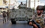 Lebanese Army soldiers patrol the clashes area in the southern suburb of the capital Beirut, on October 14, 2021. (Anwar Amro/AFP)