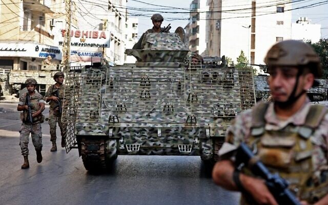 Lebanese Army soldiers patrol the clashes area in the southern suburb of the capital Beirut, on October 14, 2021. (Anwar Amro/AFP) Lebanese Army soldiers patrol the clashes area in the southern suburb of the capital Beirut, on October 14, 2021. (Anwar Amro/AFP)