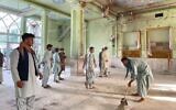 Illustrative: Afghan men inspect the damages inside a Shiite mosque in Kandahar on October 15, 2021, after a suicide bomb attack during Friday prayers (JAVED TANVEER / AFP)