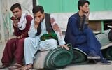 Afghan men sit in a courtyard inside a Shiite mosque in Kandahar on October 15, 2021, after a suicide bomb attack during Friday prayers (Javed TANVEER / AFP)