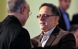 In this file photo taken on January 17, 2016, then-head of the Central Bank of Iran, Valiollah Seif (right), speaks to Iran's head of Atomic Energy Organization Ali Akbar Salehi. (Atta Kenare/AFP)