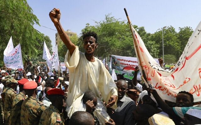 Sudanese protesters take part in a rally demanding the dissolution of the transitional government, outside the presidential palace in Khartoum on October 16, 2021. (Ashraf Shazly/AFP)