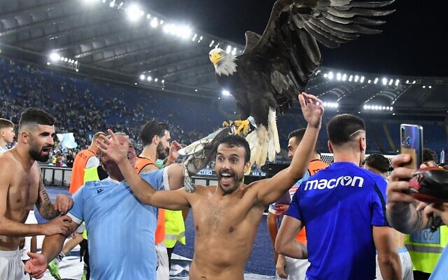 Illustrative: In this file photo taken on September 26, 2021 Lazio's Spanish forward Pedro Rodriguez Ledesma celebrates with Lazio's eagle mascotte Olimpia at the end the Italian Serie A soccer match Lazio vs AS Roma at the Olympic stadium in Rome. (Photo by Vincenzo PINTO / AFP) Illustrative: In this file photo taken on September 26, 2021 Lazio's Spanish forward Pedro Rodriguez Ledesma celebrates with Lazio's eagle mascotte Olimpia at the end the Italian Serie A soccer match Lazio vs AS Roma at the Olympic stadium in Rome. (Photo by Vincenzo PINTO / AFP)