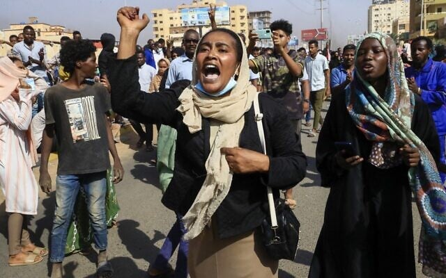 Sudanese protesters march in Khartoum to denounce apparent coup on October 25, 2021 (AFP)