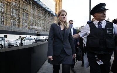 Facebook whistleblower Frances Haugen (L) leaves the Houses of Parliament in central London on October 25, 2021 after giving evidence to members of the UK parliament on the Joint Committee on the draft Online Safety Bill. - Facebook whistleblower Frances Haugen told UK lawmakers Monday that posting content featuring anger and hate "is the easiest way to grow" on the social media platform as she urged better regulation. The ex-Facebook employee, who earlier this year shared a trove of internal documents alleging it knew its products were fueling hate and harming children's mental health,  argued the platform was "unquestionably" fuelling hate. (Photo by Tolga Akmen / AFP)