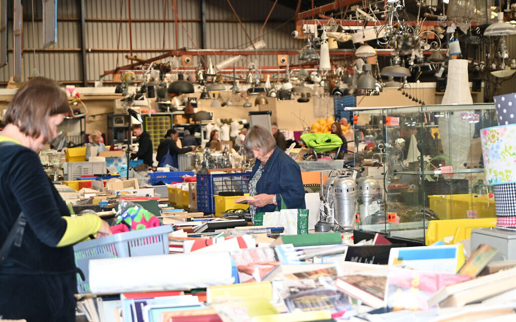 Shoppers browse through the products on sale at the warehouse store of Gideon Italiaander in Amsterdam, the Netherlands on October 11, 2021. (Cnaan Liphshiz/ JTA)