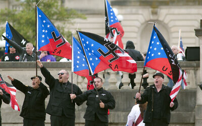 Illustrative: Members of the National Socialists Movement and the White Knights of the Klu Klux Klan salute during a rally April 21, 2012, at the Capitol in Frankfort, Kentucky. (AP Photo/John Flavell)