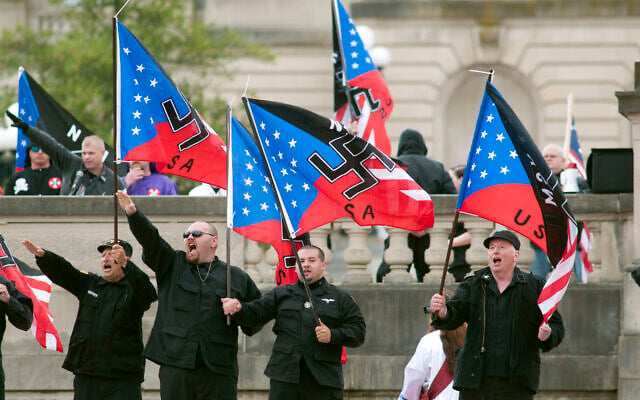 Illustrative: Members of the National Socialists Movement and the White Knights of the Klu Klux Klan salute during a rally April 21, 2012, at the Capitol in Frankfort, Kentucky. (AP Photo/John Flavell) Illustrative: Members of the National Socialists Movement and the White Knights of the Klu Klux Klan salute during a rally April 21, 2012, at the Capitol in Frankfort, Kentucky. (AP Photo/John Flavell)