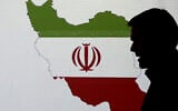 Illustrative: A cybersecurity expert stands in front of a map of Iran as he speaks to journalists about the techniques of Iranian hacking, on September 20, 2017, in Dubai, United Arab Emirates. (AP/Kamran Jebreili)