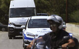 FILE -- A motorcyclist police officer escorts and guards a police van, Nicosia, Cyprus, June 24, 2019 (Petros Karadjias/AP)
