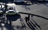 People walk one the streets and sidewalk as the sun sets in the Syrian capital Damascus, Syria, July 24, 2019. (AP Photo/Hassan Ammar)