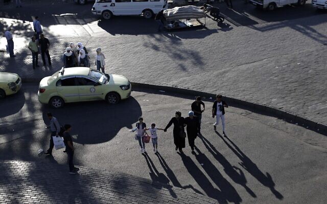 People walk one the streets and sidewalk as the sun sets in the Syrian capital Damascus, Syria, July 24, 2019. (AP Photo/Hassan Ammar) People walk one the streets and sidewalk as the sun sets in the Syrian capital Damascus, Syria, July 24, 2019. (AP Photo/Hassan Ammar)