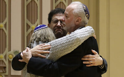 Rabbi Jeffrey Myers, right, of Tree of Life/Or L'Simcha Congregation hugs Rabbi Cheryl Klein, left, of Dor Hadash Congregation and Rabbi Jonathan Perlman during a community gathering held in the aftermath of a deadly shooting at the Tree of Life Synagogue in Pittsburgh, October 28, 2018.  (AP Photo/Matt Rourke, File)