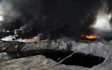 In this Oct. 4, 2016 file photo, oil fields in the town of Qayyarah burn, nearly a month after fleeing Islamic State militants set fire to the oil. (Bram Janssen/AP)