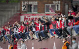 Illustrative: In this May 22, 2021 file photo Union fans cheer for their team after the German Bundesliga soccer match between 1. FC Union Berlin and RB Leipzig in Berlin, Germany. (AP/Michael Sohn)