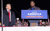 Former president Donald Trump listens as Georgia Senate candidate Herschel Walker speaks during his Save America rally in Perry, Ga., on Saturday, Sept. 25, 2021. (AP Photo/Ben Gray)