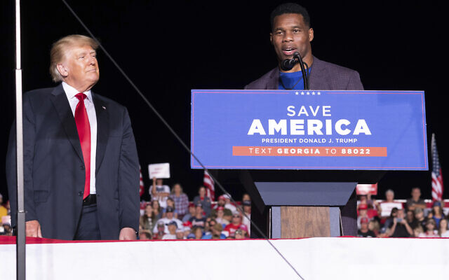 Former president Donald Trump listens as Georgia Senate candidate Herschel Walker speaks during his Save America rally in Perry, Ga., on Saturday, Sept. 25, 2021. (AP Photo/Ben Gray) Former president Donald Trump listens as Georgia Senate candidate Herschel Walker speaks during his Save America rally in Perry, Ga., on Saturday, Sept. 25, 2021. (AP Photo/Ben Gray)