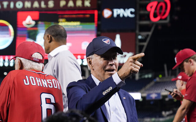 US President Joe Biden points to a fan from the Republican dugout during the Congressional baseball game at Nationals Park Wednesday, Sept. 29, 2021, in Washington. (AP Photo/Alex Brandon) US President Joe Biden points to a fan from the Republican dugout during the Congressional baseball game at Nationals Park Wednesday, Sept. 29, 2021, in Washington. (AP Photo/Alex Brandon)