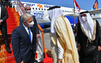 Israel's Foreign Minister Yair Lapid is met by his Bahraini counterpart, Abdullatif bin Rashid Alzayani, center right, for the first high-level visit in Manama, Bahrain, Thursday, Sept. 30, 2021 (Shlomi Amshalem/GPO via AP)