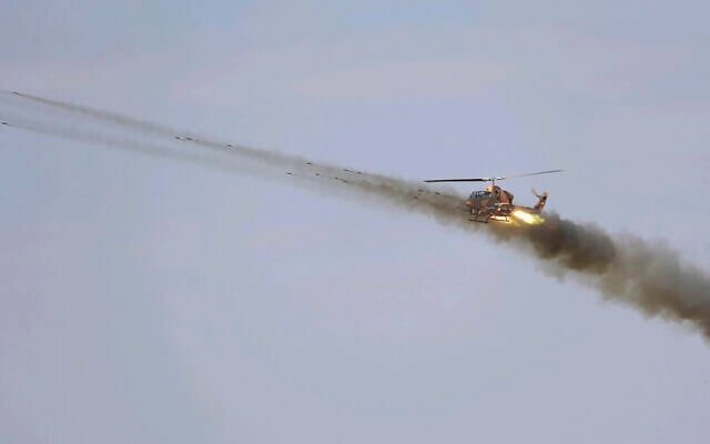 In this undated picture released by the official website of the Iranian Army on October 1, 2021, a helicopter fires in a maneuver near Iranian border with Azerbaijan. (Iranian Army via AP) In this undated picture released by the official website of the Iranian Army on October 1, 2021, a helicopter fires in a maneuver near Iranian border with Azerbaijan. (Iranian Army via AP)
