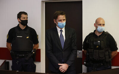 Rémy Daillet-Wiedemann, a former French politician whose popularity grew when he spread QAnon-style conspiracy theories, appears in court in Nancy, France on June 16, 2021, on charges he orchestrated the kidnapping of an 8-year-old girl whose mother had lost custody of her. (AP Photo/Jean-Francois Badias)