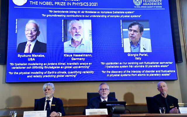 Secretary General of the Royal Swedish Academy of Sciences Goran Hansson, center, flanked at left by member of the Nobel Committee for Physics Thors Hans Hansson, left, and member of the Nobel Committee for Physics John Wettlaufer, right, announces the winners of the 2021 Nobel Prize in Physics at the Royal Swedish Academy of Sciences, in Stockholm, Sweden, Tuesday, Oct. 5, 2021. (Pontus Lundahl/TT via AP) Secretary General of the Royal Swedish Academy of Sciences Goran Hansson, center, flanked at left by member of the Nobel Committee for Physics Thors Hans Hansson, left, and member of the Nobel Committee for Physics John Wettlaufer, right, announces the winners of the 2021 Nobel Prize in Physics at the Royal Swedish Academy of Sciences, in Stockholm, Sweden, Tuesday, Oct. 5, 2021. (Pontus Lundahl/TT via AP)