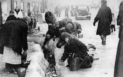 This file photo, taken in the winter months of 1942, shows citizens of Leningrad as they dig up water from a broken main, during the 900-day siege of the Russian city by German invaders (AP Photo, File)