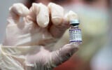 A healthcare worker holds a vial of the Pfizer COVID-19 vaccine at Jackson Memorial Hospital in Miami, October 5, 2021. (AP Photo/Lynne Sladky)