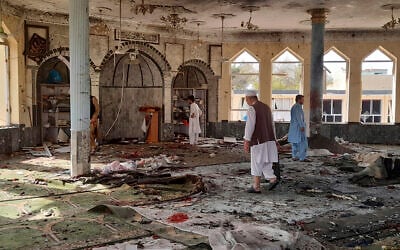 People inspect the inside of a mosque following a bombing in Kunduz province northern Afghanistan, October 8, 2021. (AP Photo/Abdullah Sahil)