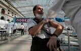 In this July 12, 2021 file photo, a medical worker administers a shot of Russia's Sputnik V coronavirus vaccine at a vaccination center in Gostinny Dvor, a huge exhibition place in Moscow, Russia. (AP/Pavel Golovkin)