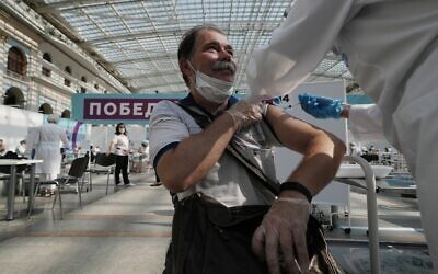 In this July 12, 2021 file photo, a medical worker administers a shot of Russia's Sputnik V coronavirus vaccine at a vaccination center in Gostinny Dvor, a huge exhibition place in Moscow, Russia. (AP/Pavel Golovkin)
